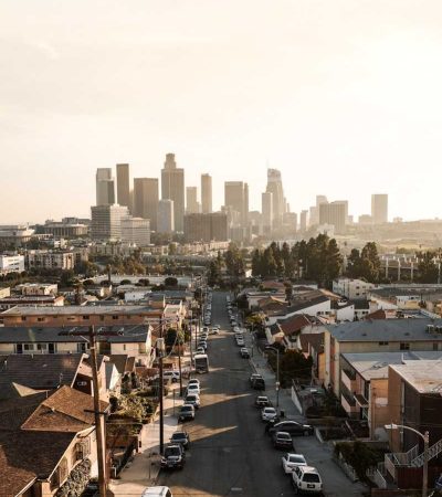 cars parked on roadside in front of houses at daytime