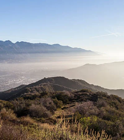 a landscape of a mountain with a city in the distance