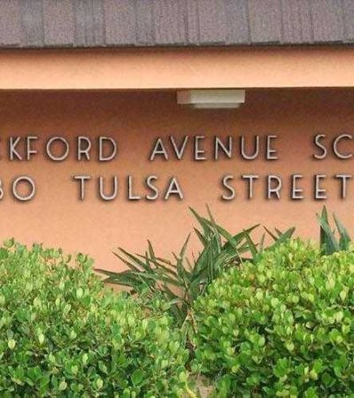 brick school building and green bushes