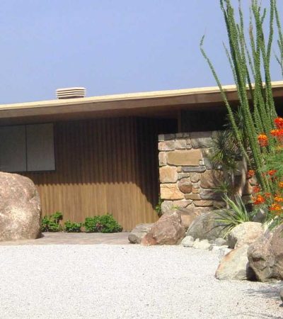 brown and biege mid century home with green and red flowers