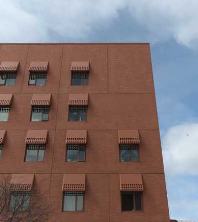 brown brick building by Micheal Maltzan