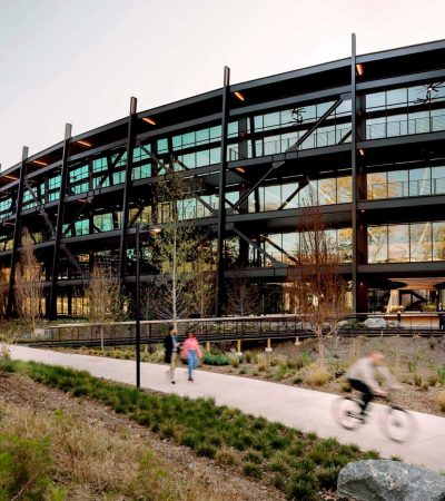 glass and steel building with sidewalk in front