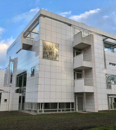 white modern three story building by richard meier