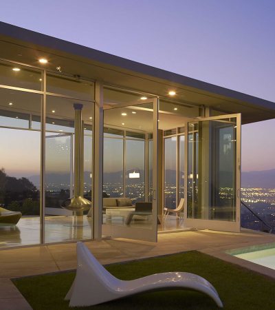 modern mansion on a hill with Los Angeles skyline in background