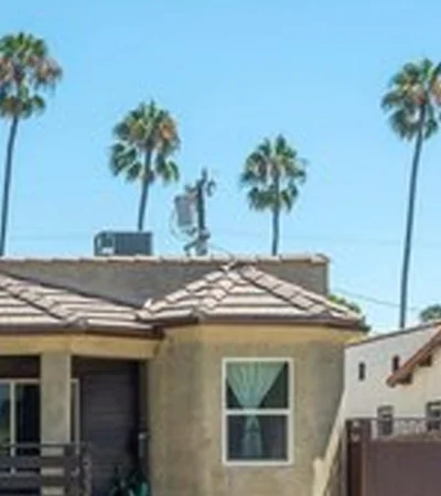 a house with palm trees in the background