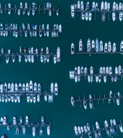 white boats on body of water at daytime