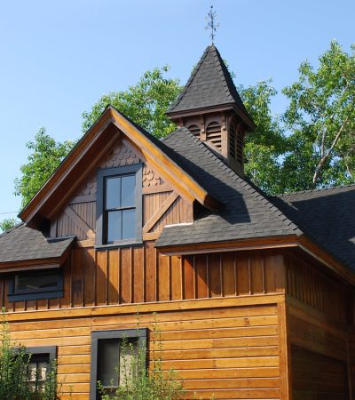 a wood house with a steeple