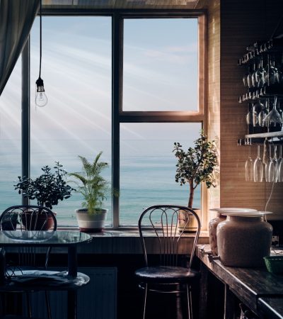 black bar stool near glass window