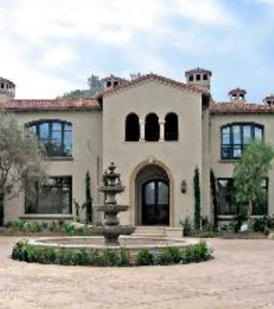 a large house with a fountain