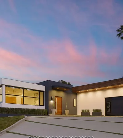 a house with a driveway and palm trees