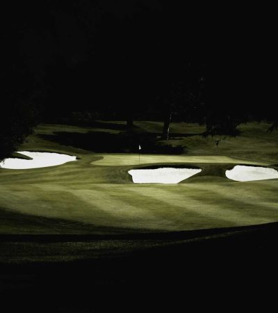 a golf course at night with the lights on