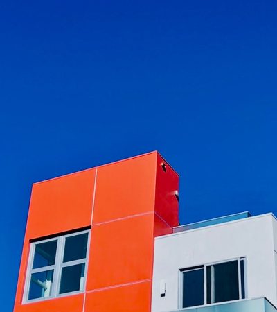 an orange and white building against a blue sky
