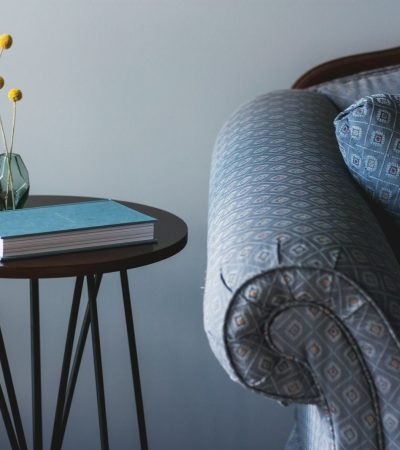 blue book on round brown end table near sofa