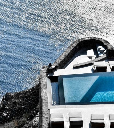 gray and white concrete building over body of water