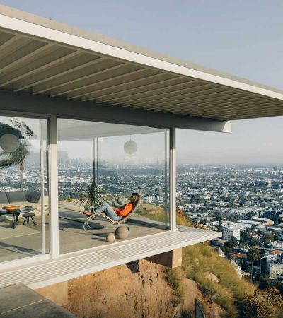 a person sitting on a balcony overlooking a city