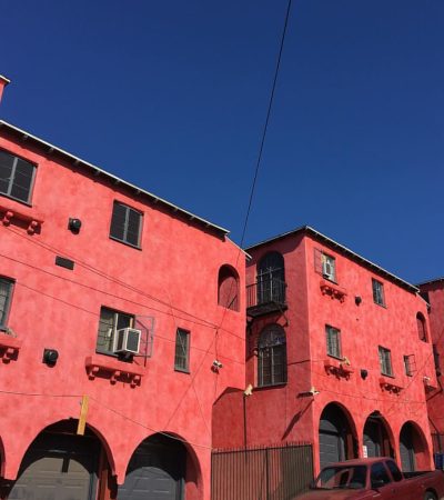a red building with a car parked in front of it