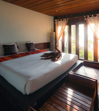 white bed linen near brown window curtain