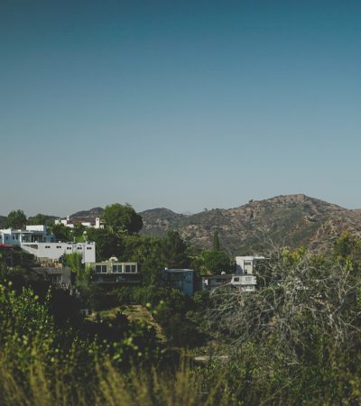a view of a mountain range with houses in the foreground