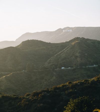 a scenic view of a mountain range with trees