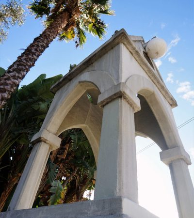 a white structure with arches and a ball on top