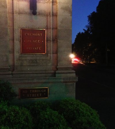 a sign on a stone wall