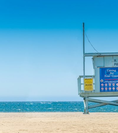 blue wooden lifeguard house on beach during daytime