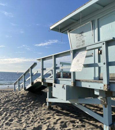 a lifeguard station sitting on the beach next to the ocean