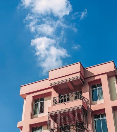 pink and white concrete building under blue sky during daytime