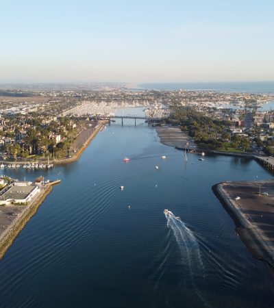 aerial view of city buildings near body of water during daytime