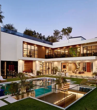 a house with a pool and a lawn