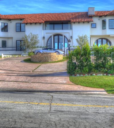 a large white house with a car parked in front of it