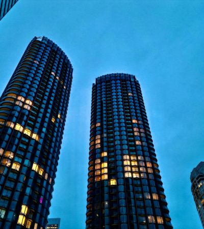 a couple of tall buildings sitting next to each other