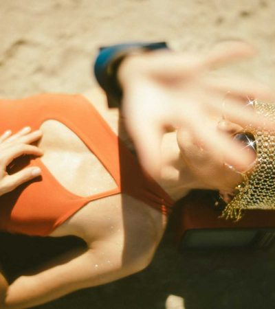 woman in orange dress lying on ground
