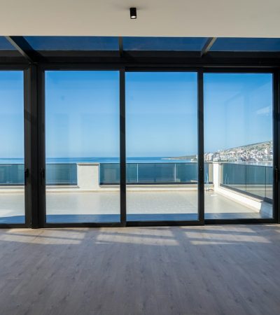 an empty room with a view of the ocean