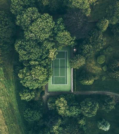 aerial photo of tennis court surrounded with trees