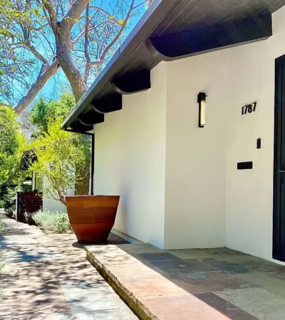 a white house with a pot on the side