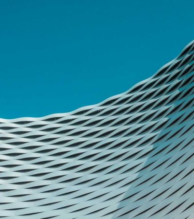 a building with wavy lines on it against a blue sky