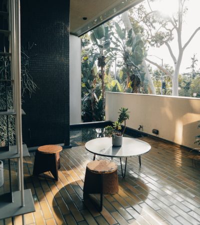 a living room with a table and two stools