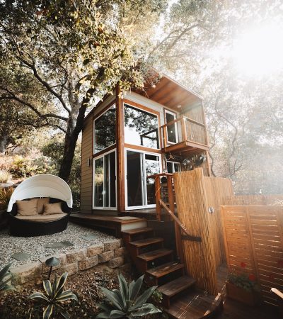brown wooden house near trees during daytime
