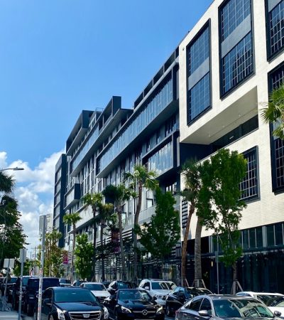 cars parked in front of white building during daytime